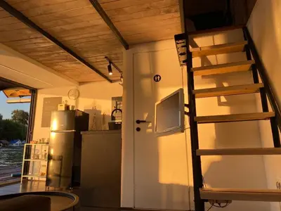 a kitchen with a ladder next to a refrigerator at Loup 1981 in Bežanija