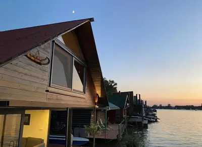 a row of houses on a dock on a body of water at Loup 1981 in Bežanija