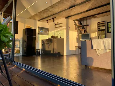 a large room with a kitchen and a large window at Loup 1981 in Bežanija