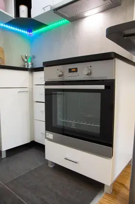 a kitchen with a black oven and white cabinets at Martha apartments in Belgrade
