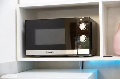 a microwave oven sitting on top of a shelf at Martha apartments in Belgrade