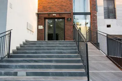 a set of stairs leading to a building with a door at Martha apartments in Belgrade