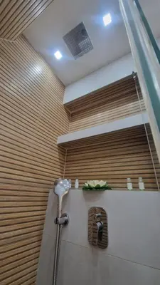 a bath tub with a shower in a room at Aurora in Belgrade