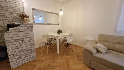a living room with a table and a couch at Aurora in Belgrade