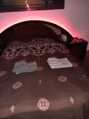a bed with two pairs of shoes and towels on it at Dorcol Sunset Apartment in Belgrade