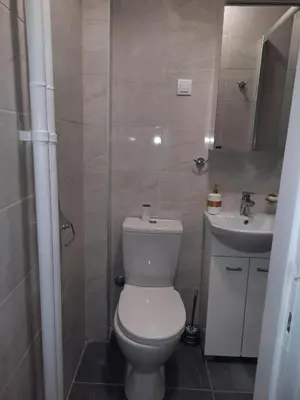 a bathroom with a white toilet and a sink at Dorcol Sunset Apartment in Belgrade