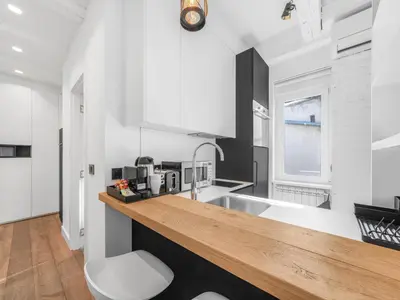 a kitchen with white walls and a wooden counter top at Enjoy B-52 Studio in Belgrade