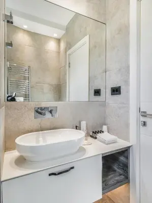 a bathroom with a white sink and a mirror at Enjoy B-52 Studio in Belgrade