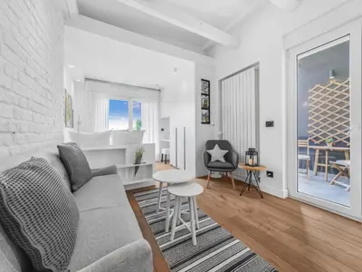 a living room with a couch and a table at Enjoy B-52 Studio in Belgrade