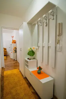 a room with an orange table and a mirror at Golden Place Belgrade in Belgrade