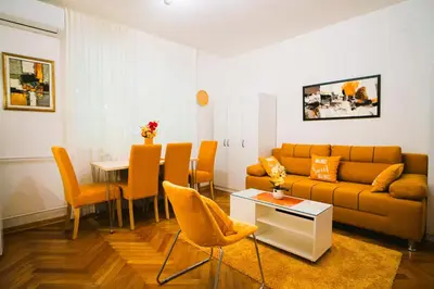 a living room with a couch and a table at Golden Place Belgrade in Belgrade