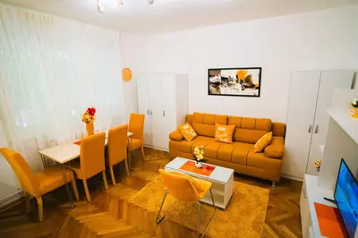 a living room with a couch and a table at Golden Place Belgrade in Belgrade