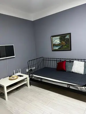 a blue room with a bed and a table at Sandra City Center Apartment in Belgrade