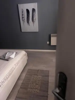 a bedroom with a bed and a picture on the wall at Sandra City Center Apartment in Belgrade