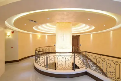 a spiral staircase in a building with a large ceiling at Hotel Majdan in Belgrade