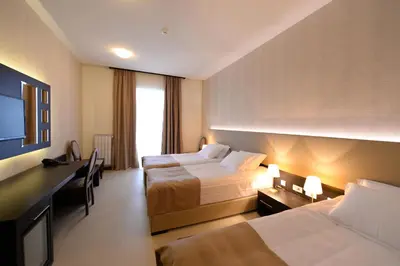 a hotel room with two beds and a television at Hotel Majdan in Belgrade