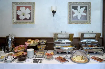 a buffet with food on a table in a room at Hotel Majdan in Belgrade