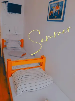 two beds in a room with a sign that says earthquake at Jasmin in Belgrade