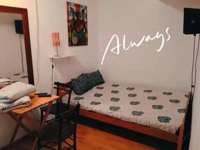 a bedroom with a bed and a table and a sign at Jasmin in Belgrade