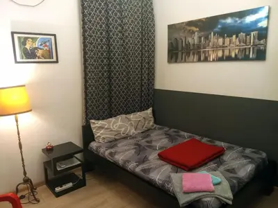 a room with a couch with a red pillow on it at JASMIN suites in Belgrade