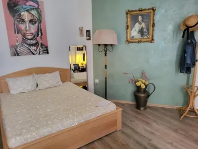 a bedroom with a bed and a picture on the wall at JASMIN suites in Belgrade