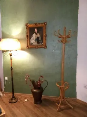 a room with a lamp and a picture on the wall at JASMIN suites in Belgrade