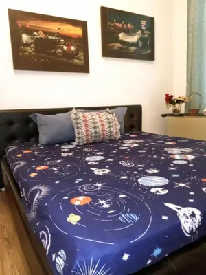a bed with a blue comforter on it at JASMIN suites in Belgrade