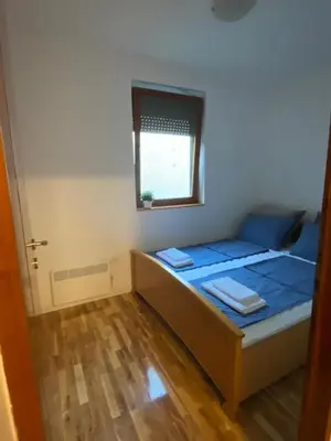 a small room with a bed and a window at House Reko in Novi Grad