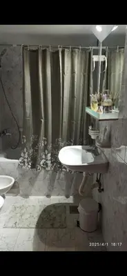 a bathroom with a sink and a shower curtain at Apartman Oaza Olja in Belgrade