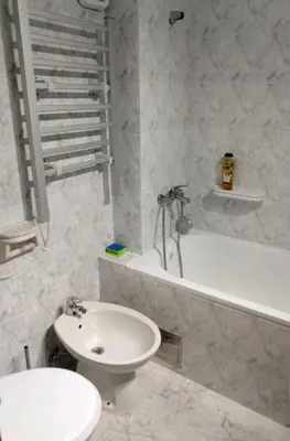 a bathroom with a sink and a toilet and a tub at Apartman Oaza Olja in Belgrade