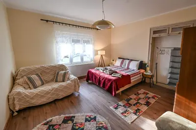 a living room with a bed and a couch at Bukovički mir in Arandjelovac