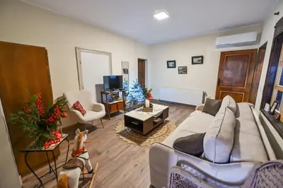 a living room with a couch and a christmas tree at Bukovički mir in Arandjelovac