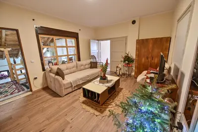 a living room with a couch and a christmas tree at Bukovički mir in Arandjelovac