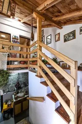 a spiral staircase in a kitchen with wooden ceilings at Bukovički mir in Arandjelovac