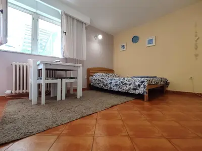 a room with a table and a bed and a desk at Ada Belgrade Apartment in Belgrade