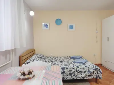 a bedroom with two beds and a table at Ada Belgrade Apartment in Belgrade