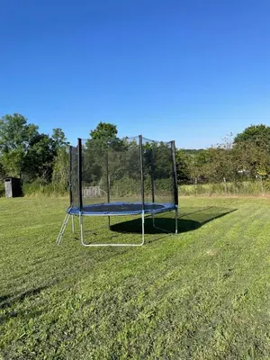 a trampoline in the middle of a field at Deda Momirov zavičaj in Tulež