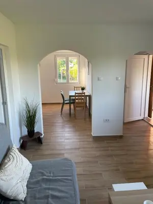 a living room with a couch and a table at Deda Momirov zavičaj in Tulež