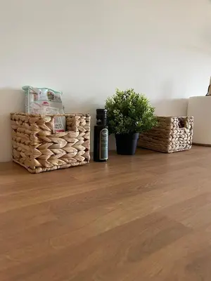 a bottle of wine and baskets on a wooden floor at Deda Momirov zavičaj in Tulež