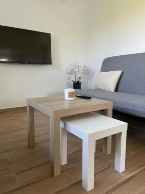 a living room with a table and a couch at Deda Momirov zavičaj in Tulež