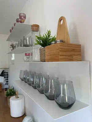 a row of wine glasses sitting on a shelf at Deda Momirov zavičaj in Tulež