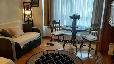 a living room with a couch and a table at Modern Lux Studio w Inside parking 5 min from Skadarlija, Republic Sqre in Belgrade