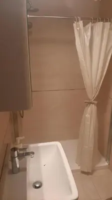a bathroom with a sink and a shower curtain at Modern Lux Studio w Inside parking 5 min from Skadarlija, Republic Sqre in Belgrade