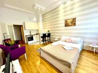 a living room with a bed and a kitchen at DORA stan na dan Novi Beograd Savada Blok A, parking 5 evra dan in Belgrade