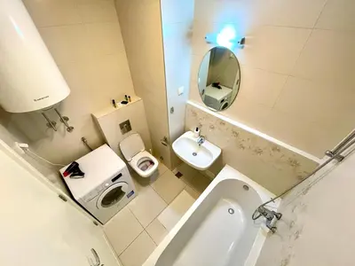 a bathroom with a sink and a toilet and a mirror at DORA stan na dan Novi Beograd Savada Blok A, parking 5 evra dan in Belgrade