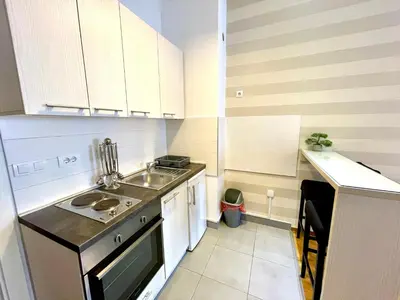 a small kitchen with white cabinets and a sink at DORA stan na dan Novi Beograd Savada Blok A, parking 5 evra dan in Belgrade