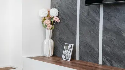 a vase with flowers in it sitting on a shelf at 9 Nine - Luxury Apartments & Suites in Belgrade