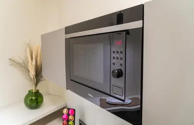 a microwave oven hanging on a wall in a kitchen at 9 Nine - Luxury Apartments & Suites in Belgrade