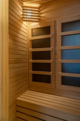 a sauna with wood paneling and a light fixture at 9 Nine - Luxury Apartments & Suites in Belgrade