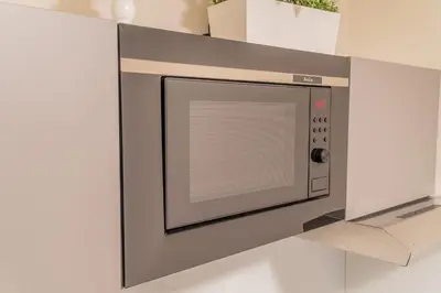 a microwave oven is mounted on a wall at 9 Nine - Luxury Apartments & Suites in Belgrade